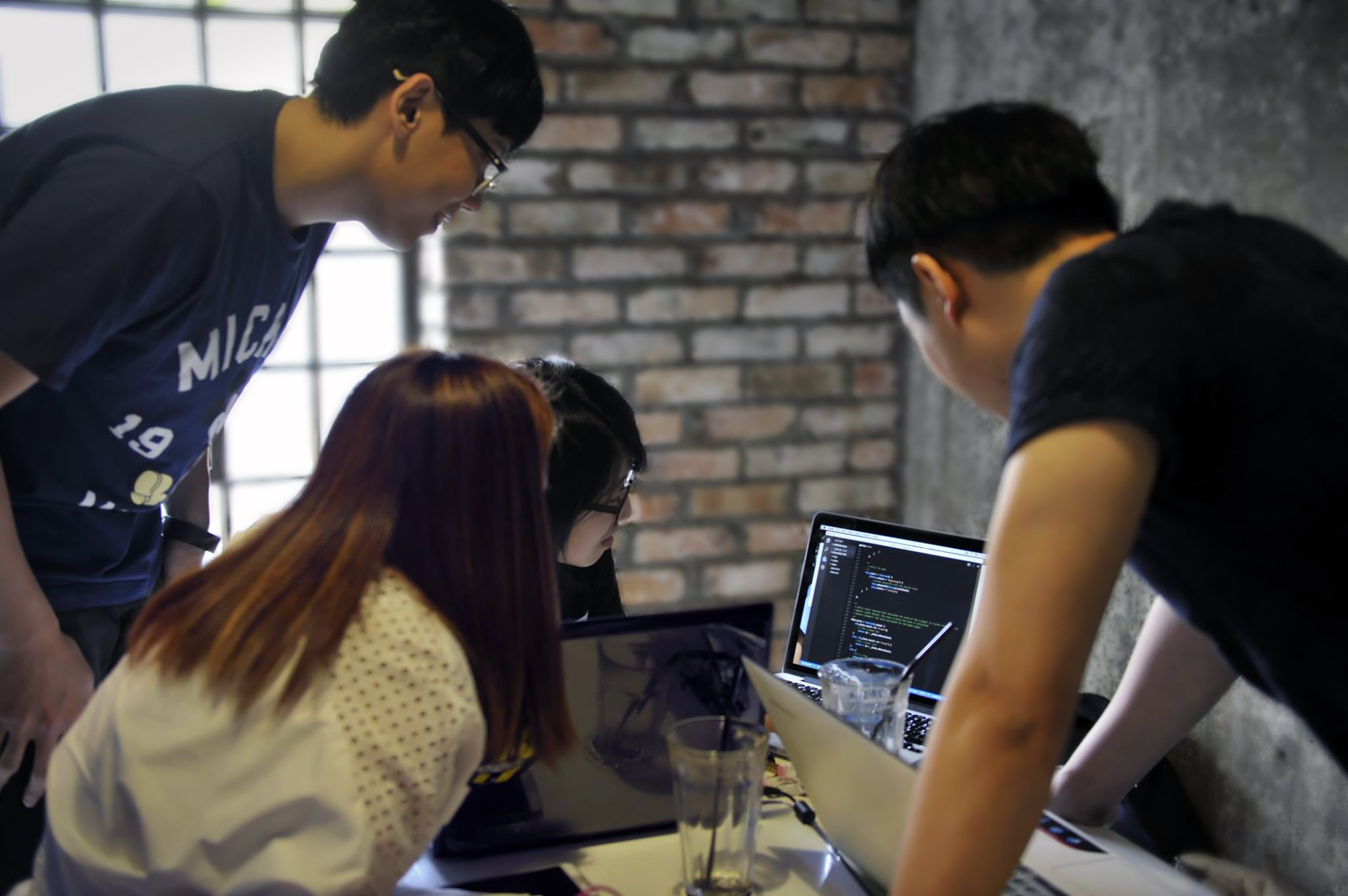 four people working on code